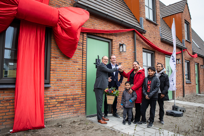Remco Pols (Ymere) en Frits Lely (Van Wijnen) feliciteren de eerste huurders met hun nieuwe woning in het Tudorpark.